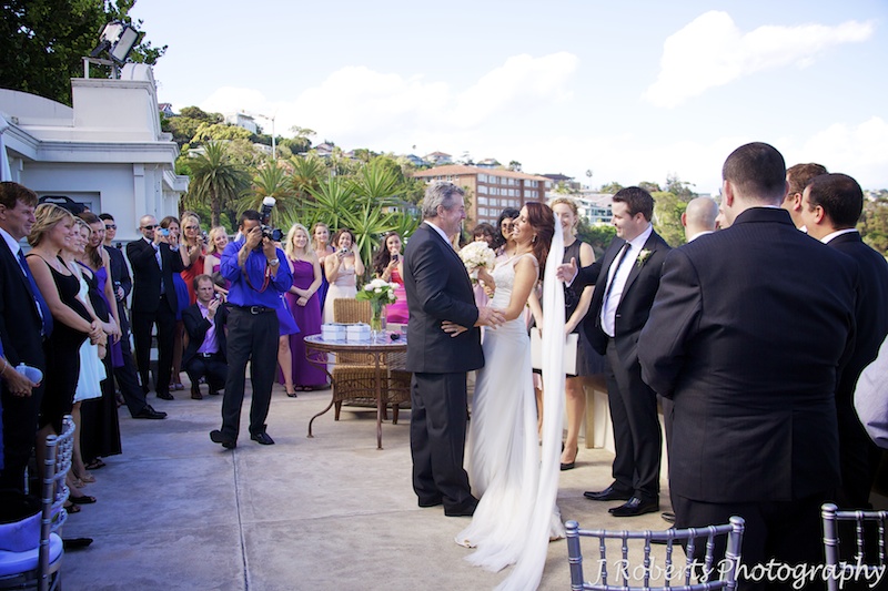 Bride being handed over to the groom by her father - wedding photography sydney